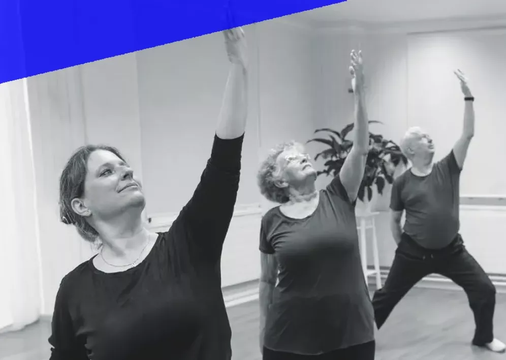 Backstage Studio: Three students standing next to each other during a yoga class.